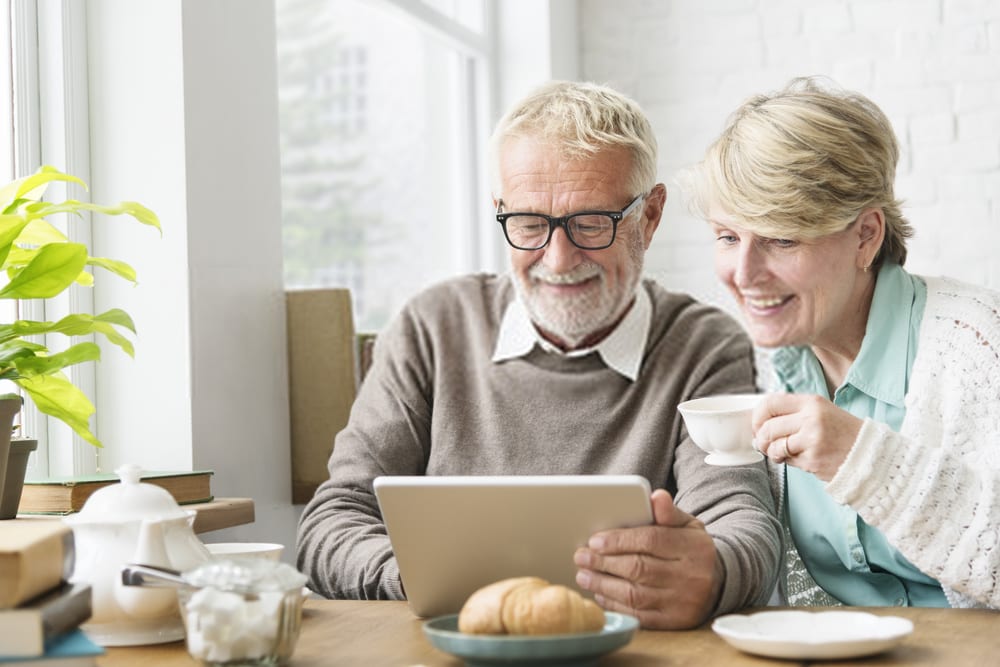 Elder Couple Reading on Tablet